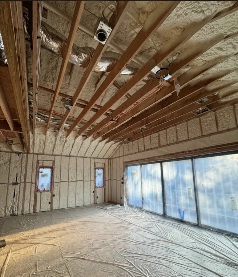 Interior walls and ceiling insulated with spray foam during new construction in Flint